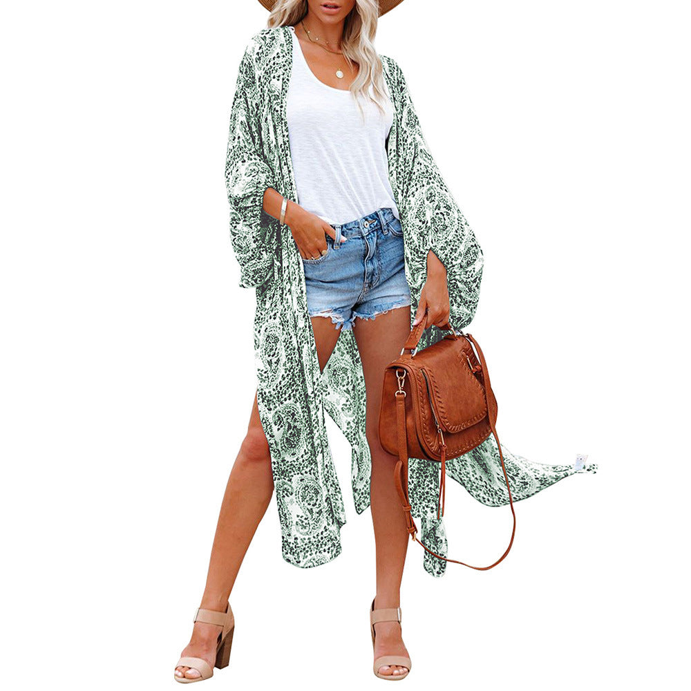 Rust-colored boho kimono-style cover-up with white intricate patterns and tassel detailing—lightweight, flowy, and perfect for summer layering.