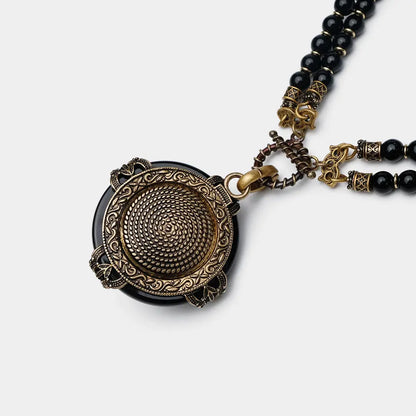 Vintage bee pendant necklace with natural black agate beads and antique copper detailing.