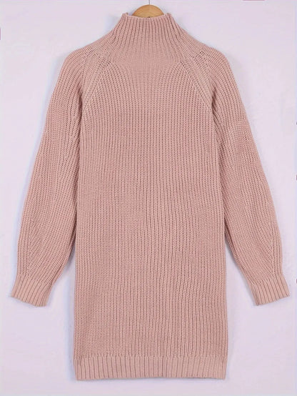 A light pink ribbed knit turtleneck sweater dress with long raglan sleeves, shown hanging on a wooden hanger against a plain light background.