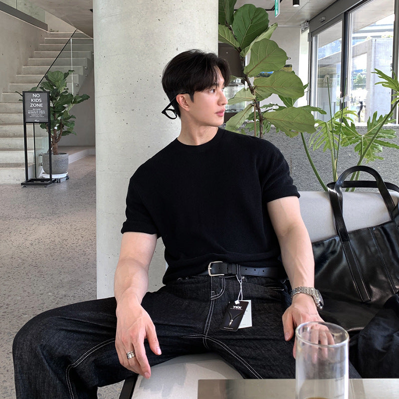 A stylish man wearing premium short sleeve t-shirts in charcoal gray, black, and forest green, highlighting the modern fit and versatile design.