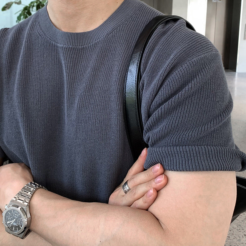 A stylish man wearing premium short sleeve t-shirts in charcoal gray, black, and forest green, highlighting the modern fit and versatile design.