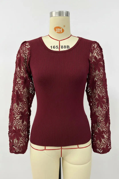 A women's long-sleeve top in deep burgundy, featuring a ribbed body and sheer floral lace sleeves, displayed on a cream-colored dress form mannequin.