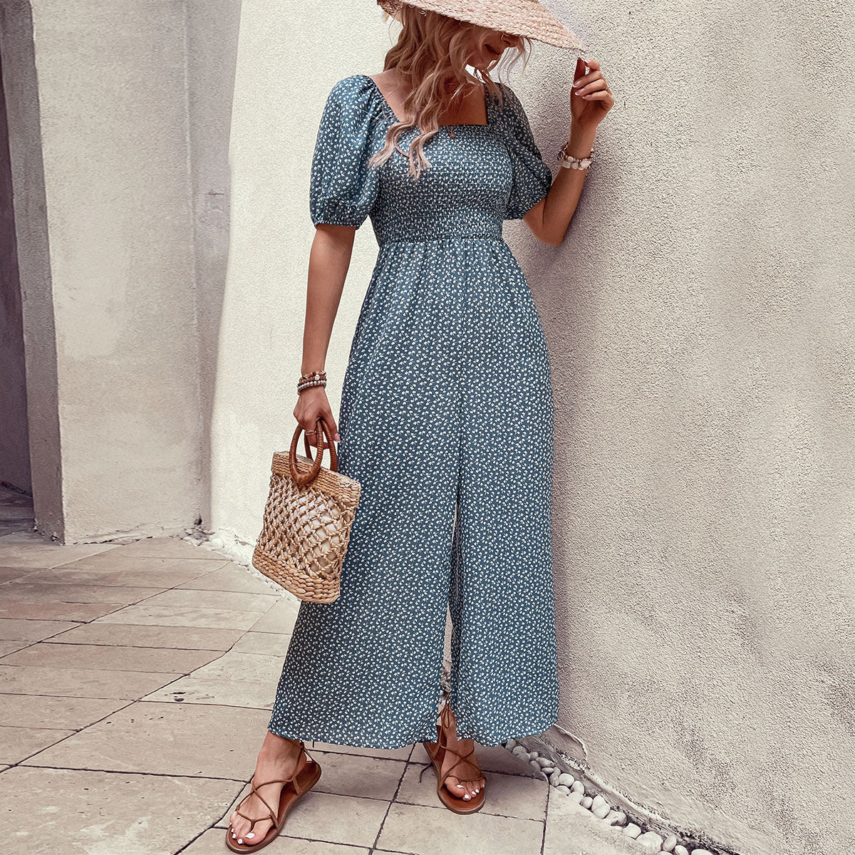 Elegant black floral jumpsuit with square neckline, puffed short sleeves, and wide-leg pants – stylish, breathable, and perfect for casual or chic occasions.