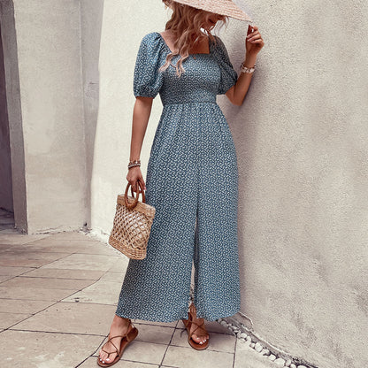 Elegant black floral jumpsuit with square neckline, puffed short sleeves, and wide-leg pants – stylish, breathable, and perfect for casual or chic occasions.
