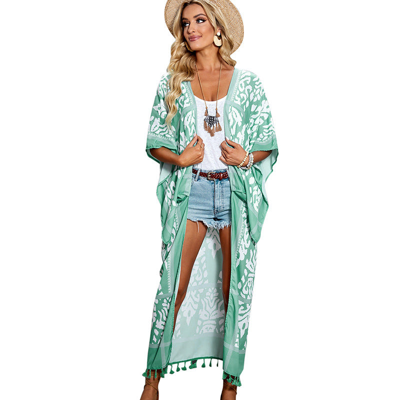 Rust-colored boho kimono-style cover-up with white intricate patterns and tassel detailing—lightweight, flowy, and perfect for summer layering.