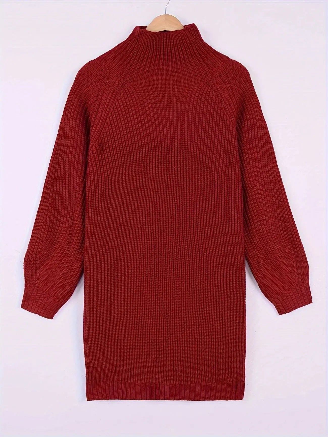 A ribbed knit mock-neck sweater dress in a deep red color, hanging on a wooden hanger against a plain white background.