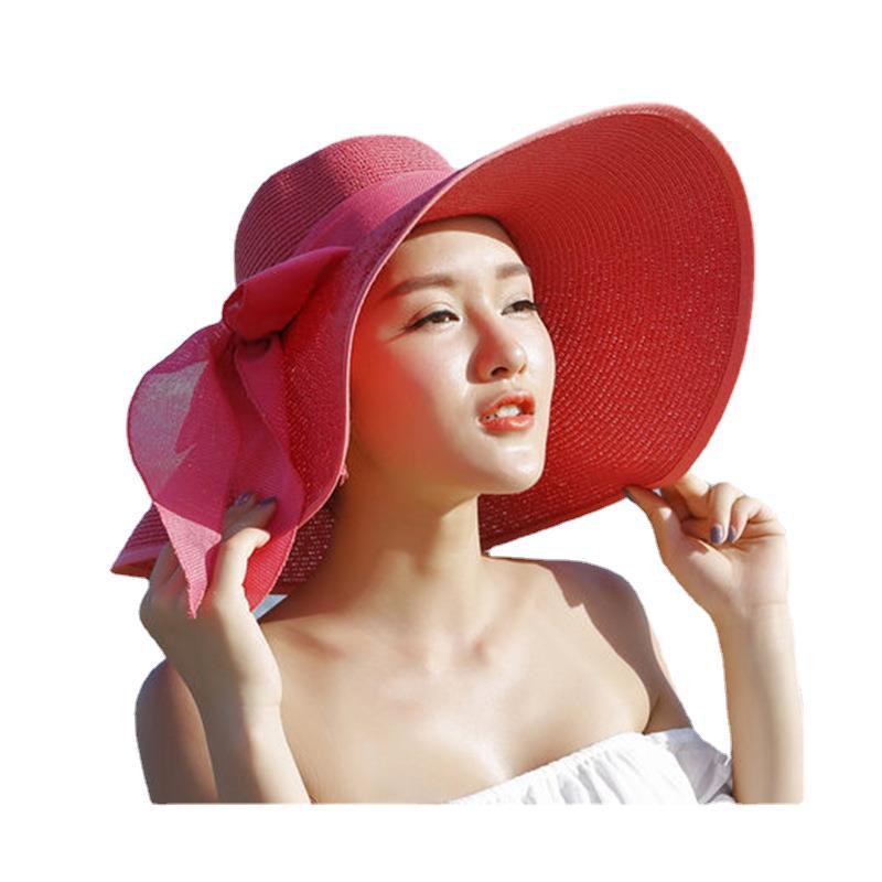 Elegant wide-brim sun hat with a bow detail, available in multiple colors including beige, black, white, pink, and blue—stylish, lightweight, and perfect for sunny days.