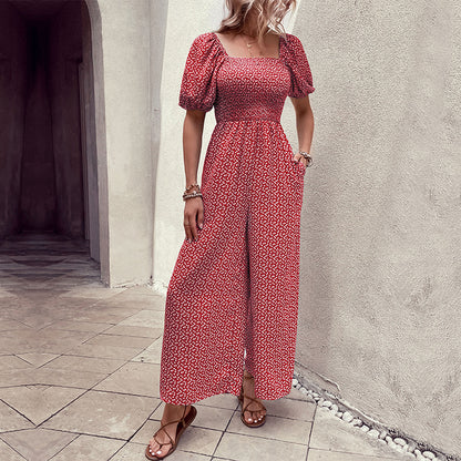 Elegant black floral jumpsuit with square neckline, puffed short sleeves, and wide-leg pants – stylish, breathable, and perfect for casual or chic occasions.