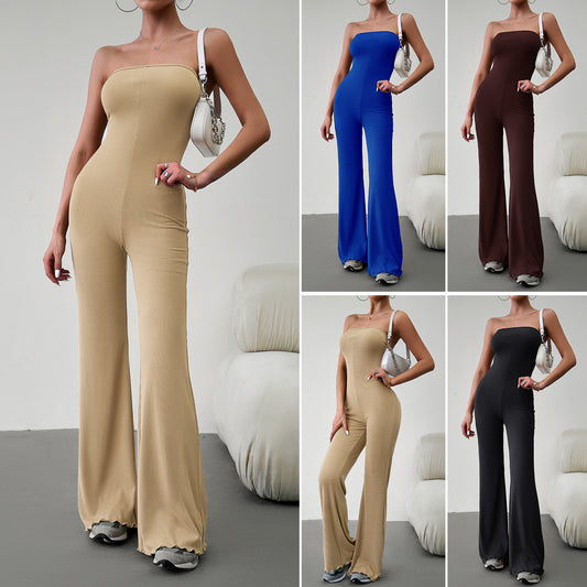 Elegant strapless jumpsuit available in beige, blue, brown, light beige, and black – form-fitting with a flared bottom, paired with sneakers and a white handbag.