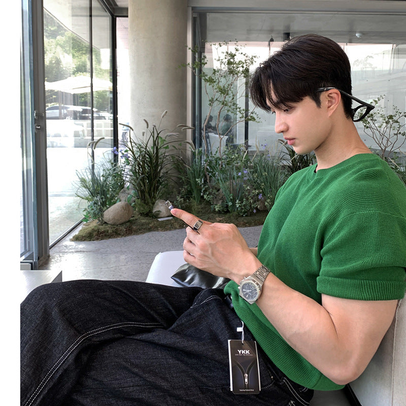 A stylish man wearing premium short sleeve t-shirts in charcoal gray, black, and forest green, highlighting the modern fit and versatile design.