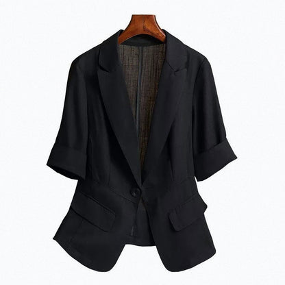 Black tailored blazer with a single-button closure, structured shoulders, front flap pockets, and rolled-up sleeves—modern, elegant, and perfect for office or casual styling.