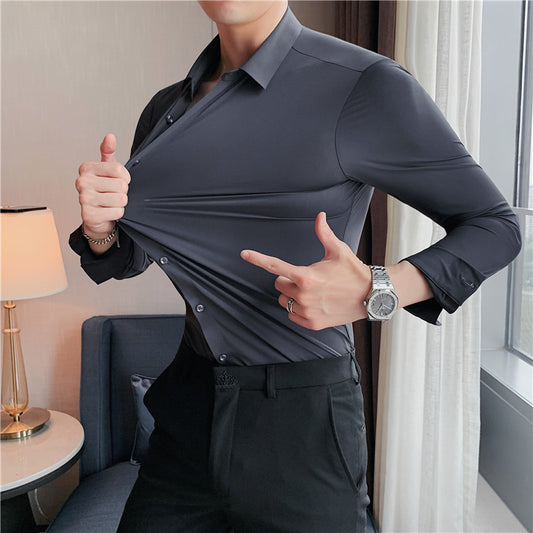 Premium stretch silk men’s long-sleeve button-up shirt in a solid white color, worn by a seated individual, showcasing smooth luxurious fabric and business-ready styling.