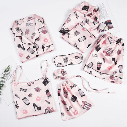 Luxury silk sleepwear set featuring a robe, nightgown, camisole, and long pants with delicate white lace trim—elegant, soft, and perfect for sleep and lounge.