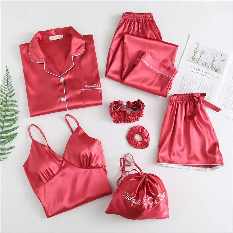 Luxury silk sleepwear set featuring a robe, nightgown, camisole, and long pants with delicate white lace trim—elegant, soft, and perfect for sleep and lounge.