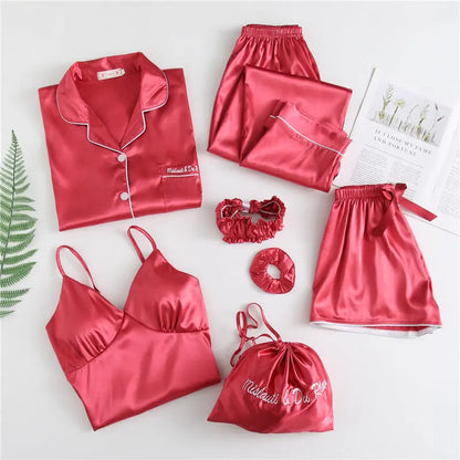 Luxury silk sleepwear set featuring a robe, nightgown, camisole, and long pants with delicate white lace trim—elegant, soft, and perfect for sleep and lounge.
