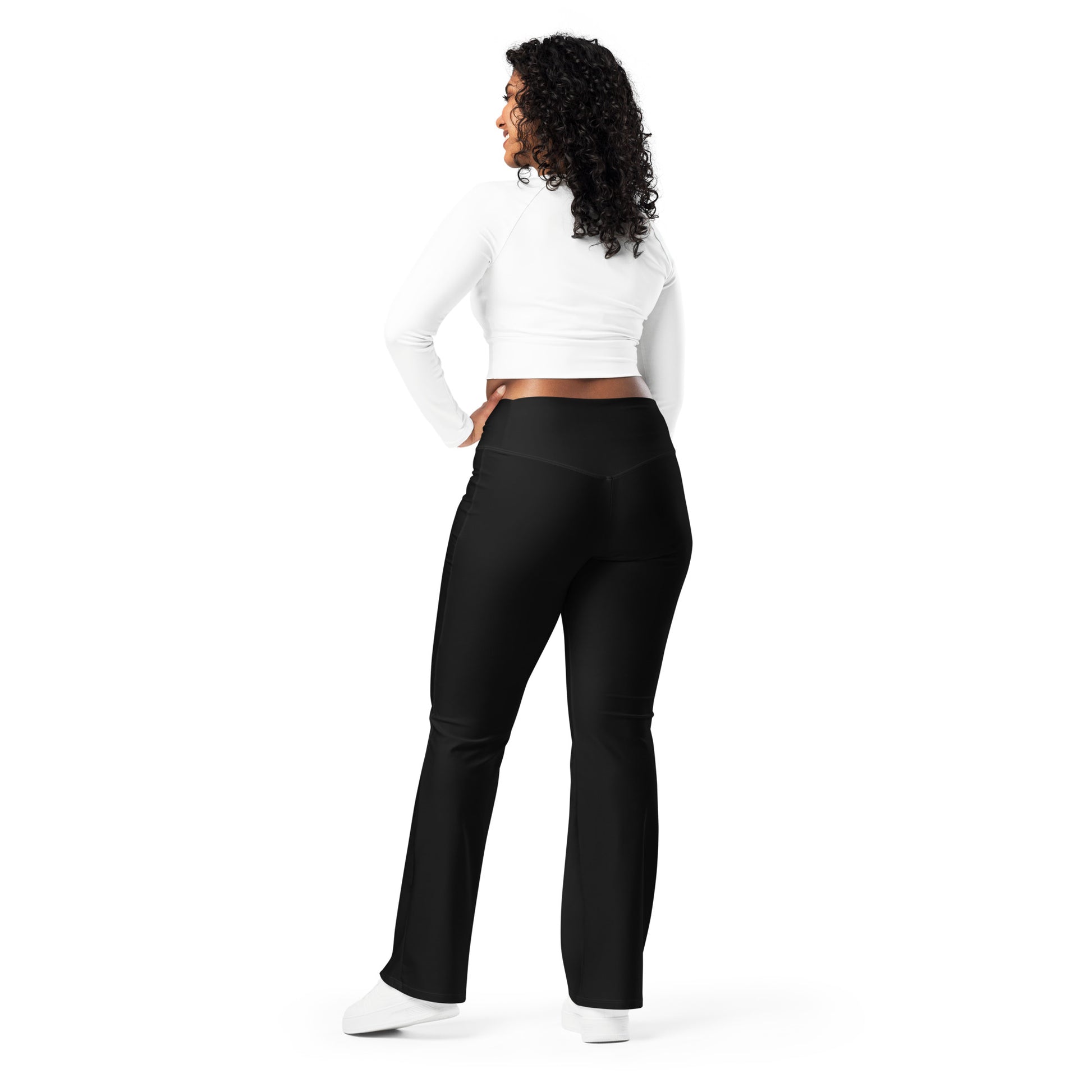 Person wearing black leggings paired with a beige crop top, white button-up jacket, and white sneakers—modern, stylish, and perfect for casual fashion.