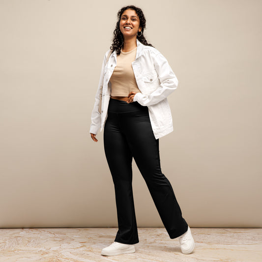 Person wearing black leggings paired with a beige crop top, white button-up jacket, and white sneakers—modern, stylish, and perfect for casual fashion.