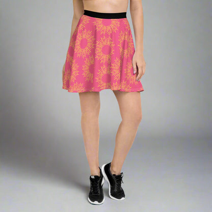 Pink skirt featuring a striking yellow sunburst pattern, paired with a black waistband and athletic shoes—bold, vibrant, and perfect for making a statement.