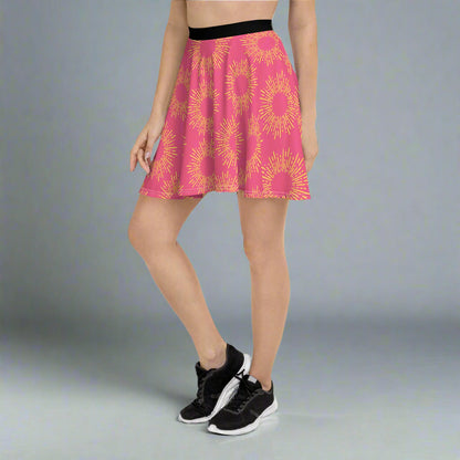 Pink skirt featuring a striking yellow sunburst pattern, paired with a black waistband and athletic shoes—bold, vibrant, and perfect for making a statement.