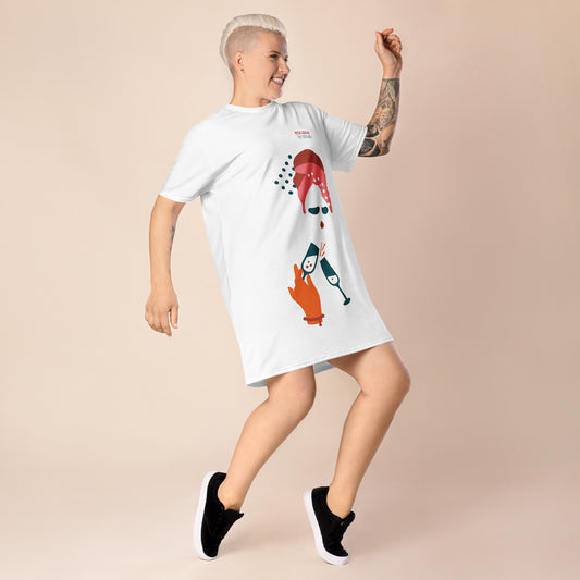 White t-shirt dress featuring a bold graphic design with sunglasses, a pink polka-dot headscarf, red lips, and a wine-pouring illustration—effortless, stylish, and perfect for confident fashion.