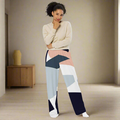 Woman wearing high-waist wide-leg pants with a geometric print in navy, light blue, pink, and white—styled with a beige long-sleeve shirt for an effortlessly chic look.