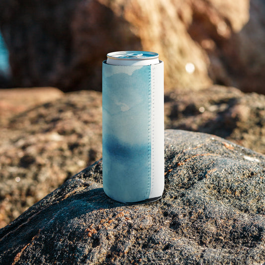 Can wrapped in a blue and white sleeve with stitched seam, placed on a rock—sleek, insulated, and perfect for casual drink accessories.