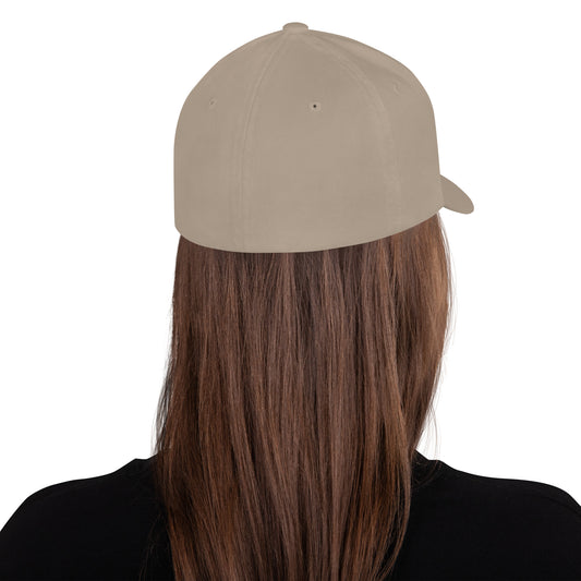 White baseball cap featuring embroidered text reading ‘GOOD VIBES ONLY’ in yellow, placed beside black headphones and stationery—modern, stylish, and perfect for casual wear.