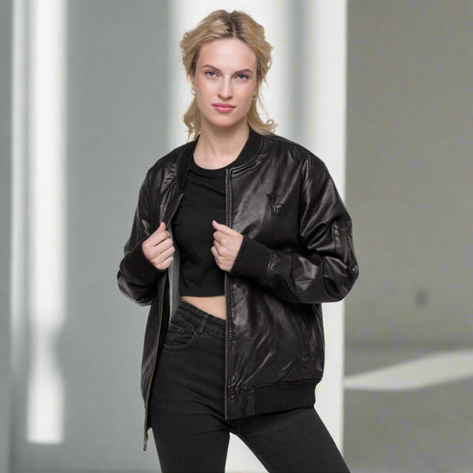 Black faux leather jacket with ribbed cuffs and hem, a zip-up front, soft grey inner lining, and a small embroidered deer logo on the chest—stylish, structured, and perfect for casual or dressy outfits.