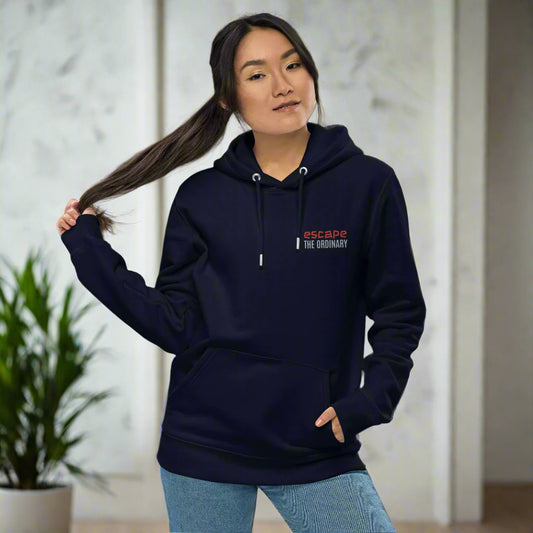 Minimalist street-style hoodie available in navy blue, black, and white, featuring a bold text design on the chest reading ‘escape’ in red and ‘THE ORDINARY’ in white, along with a front pocket and adjustable metal-tipped drawstring hood.