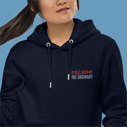 Minimalist street-style hoodie available in navy blue, black, and white, featuring a bold text design on the chest reading ‘escape’ in red and ‘THE ORDINARY’ in white, along with a front pocket and adjustable metal-tipped drawstring hood.