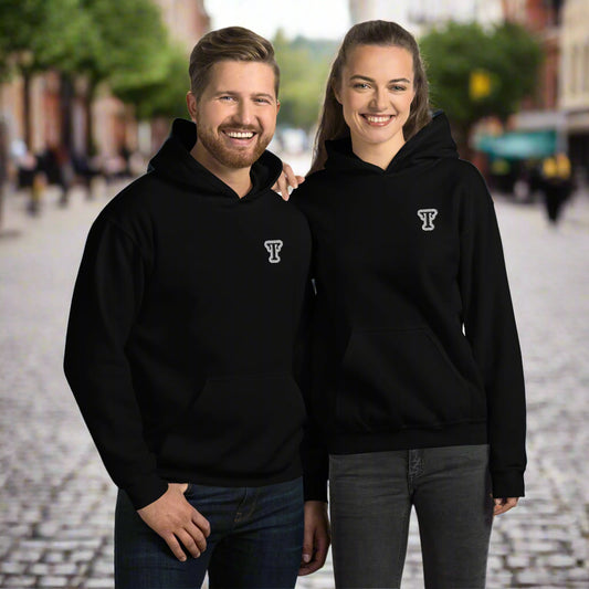 Two people wearing black hoodies featuring an embroidered letter ‘T’ on the left chest, standing close together with arms around each other—modern, stylish, and available in navy blue, white, and grey.