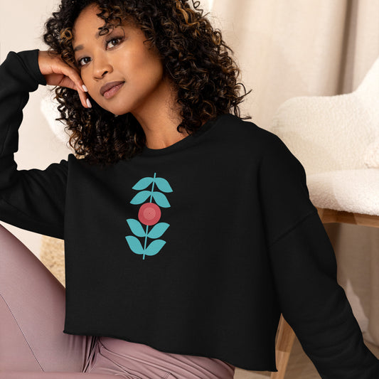 Black sweatshirt featuring a bold stylized floral graphic with blue leaves and a red circular center—modern, artistic, and perfect for casual wear.